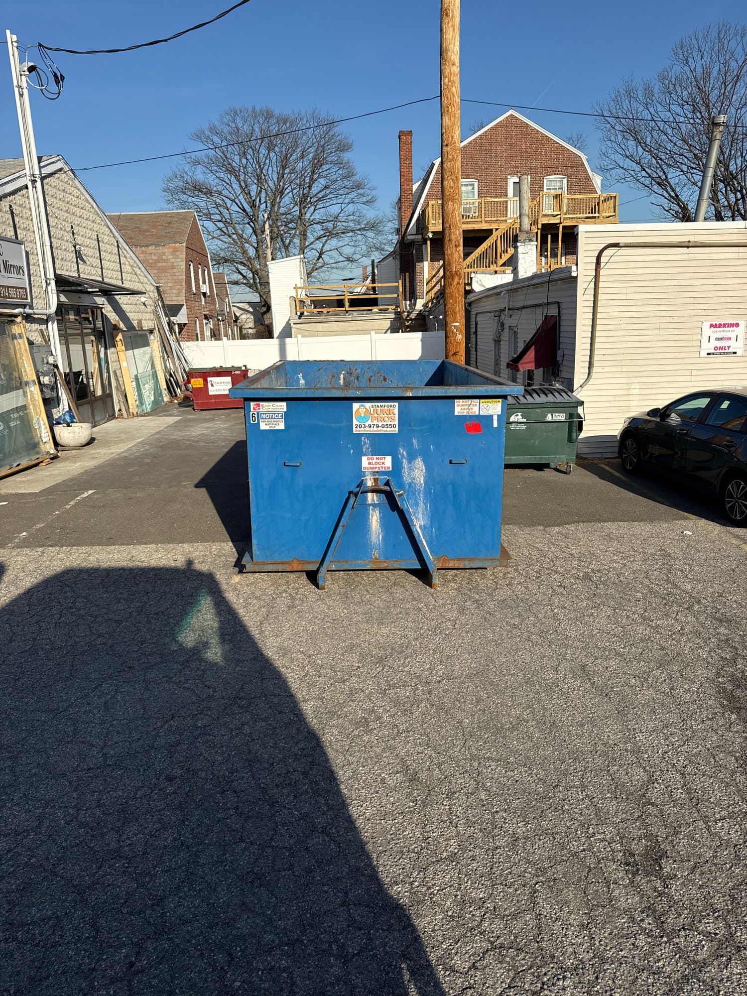 blue-dumpster-commercial-site in Fairfield, CT by Stamford Junk Pros