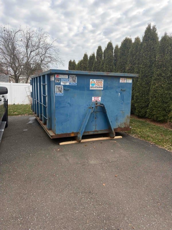 blue-dumpster-container in Milford, CT by Stamford Junk Pros