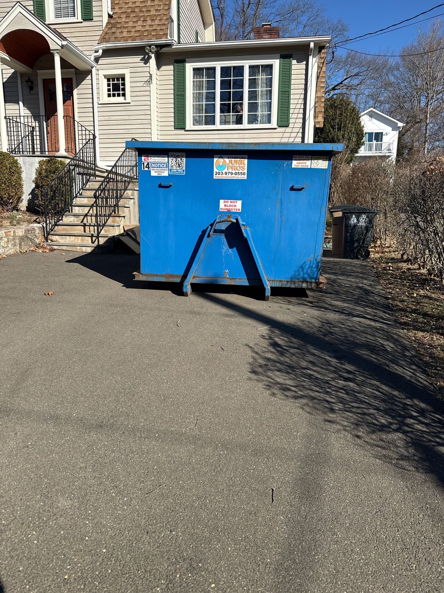 blue dumpster residential in Darien, CT by Stamford Junk Pros