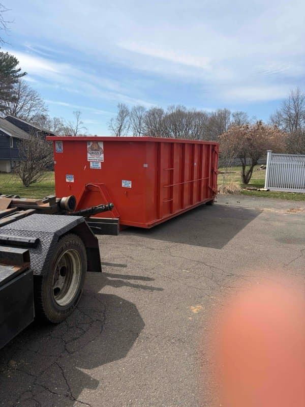 red-dumpster-delivery in Westport, CT by Stamford Junk Pros